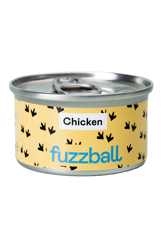 A can of Fuzzball cat food with a yellow label featuring black silhouette illustrations of chicken and the brand name.